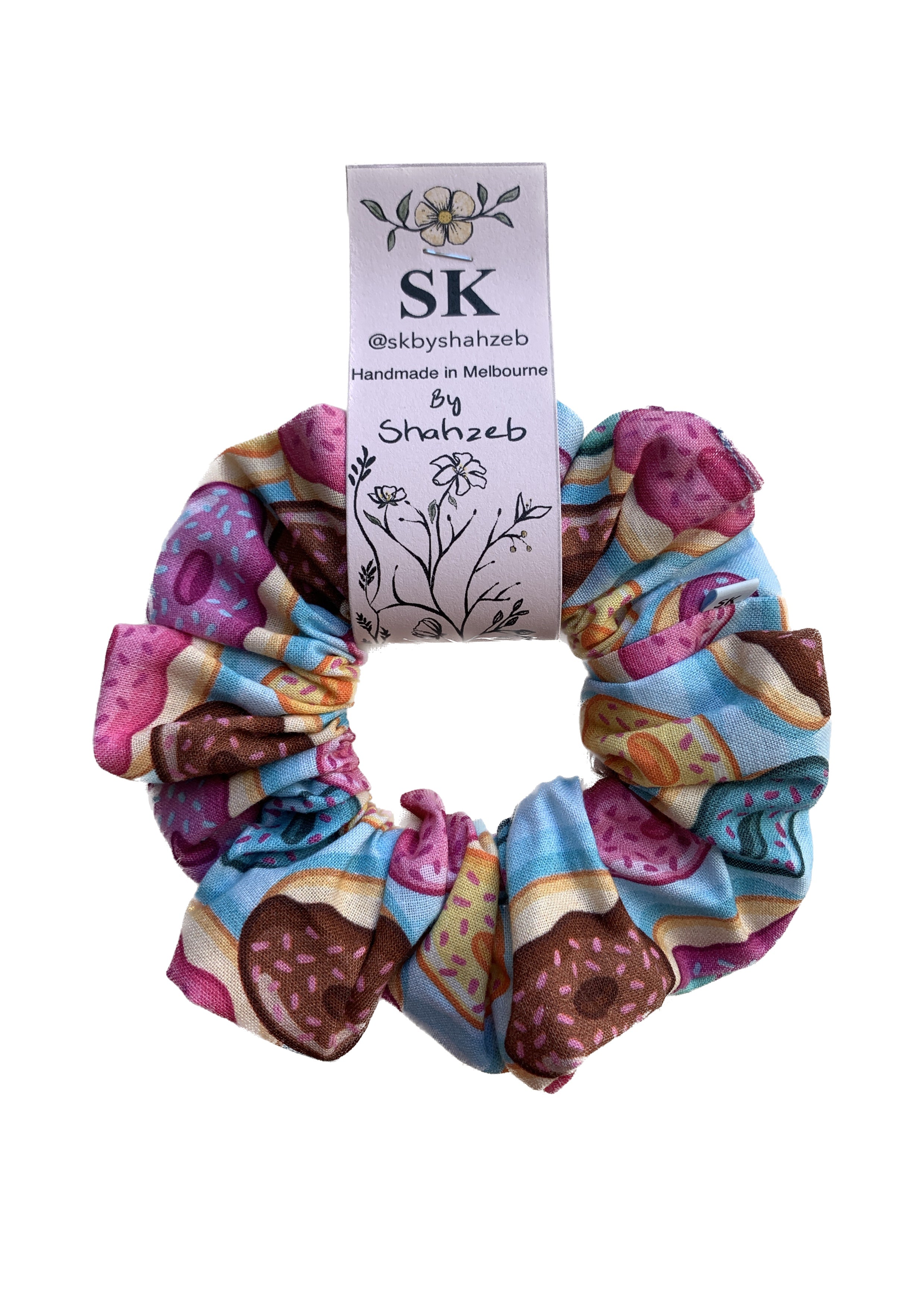 A fabric scrunchie featuring a colorful donut print.
