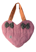A heart-shaped quilted fabric bag in a pink and white gingham pattern, featuring two black and white gingham bows on the front and orange-brown shoulder straps, shown against a plain white background.