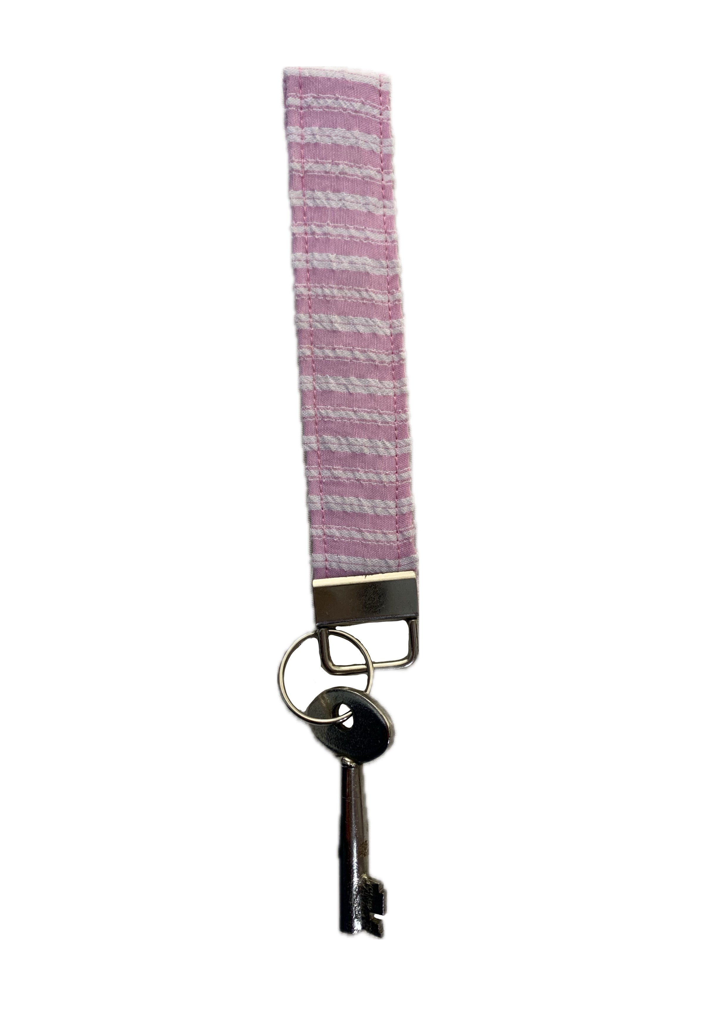 A pink and white patterned fabric keychain with a silver metal clasp and a key attached, shown against a plain white background.