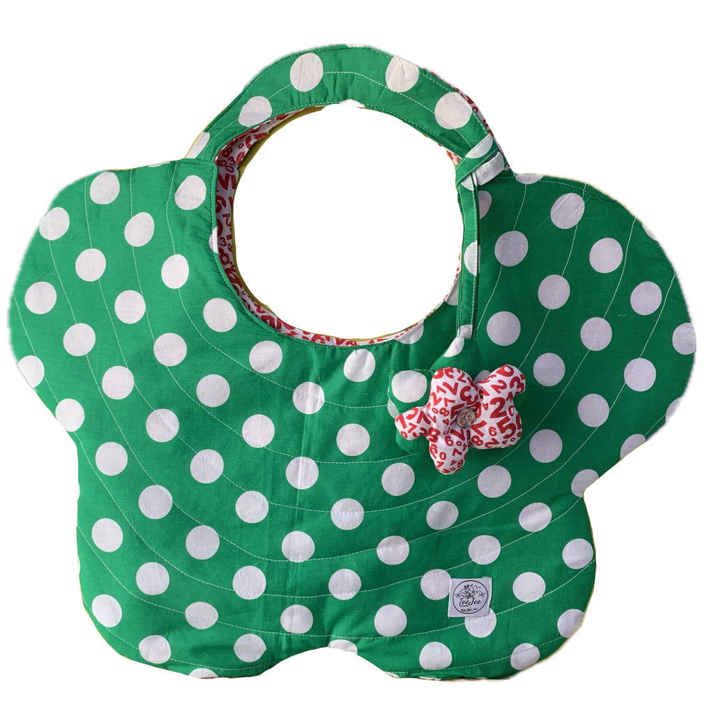 A green quilted tote bag with white polka dots.