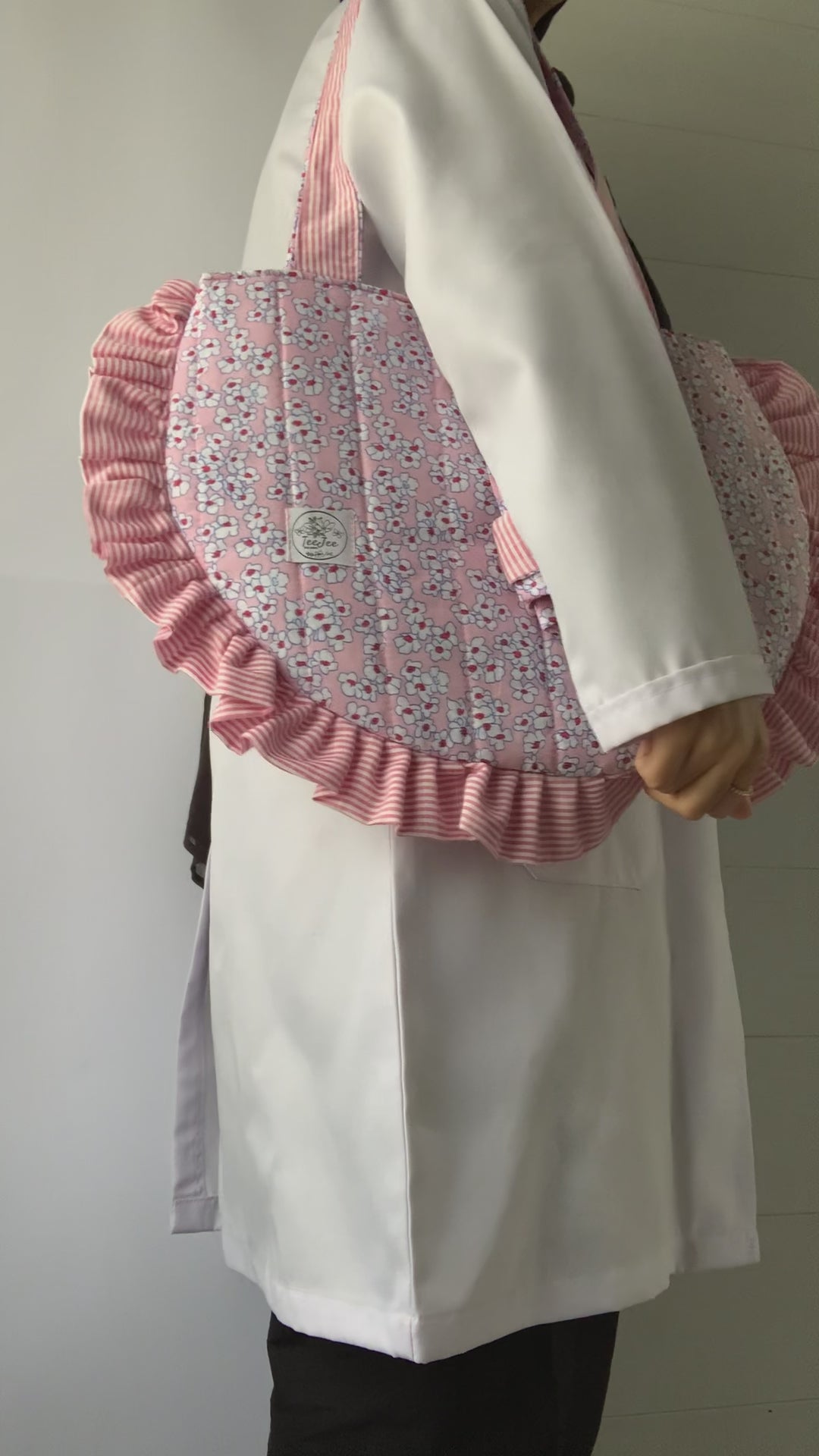 The video shows the tote bag being carried to provide a size reference.