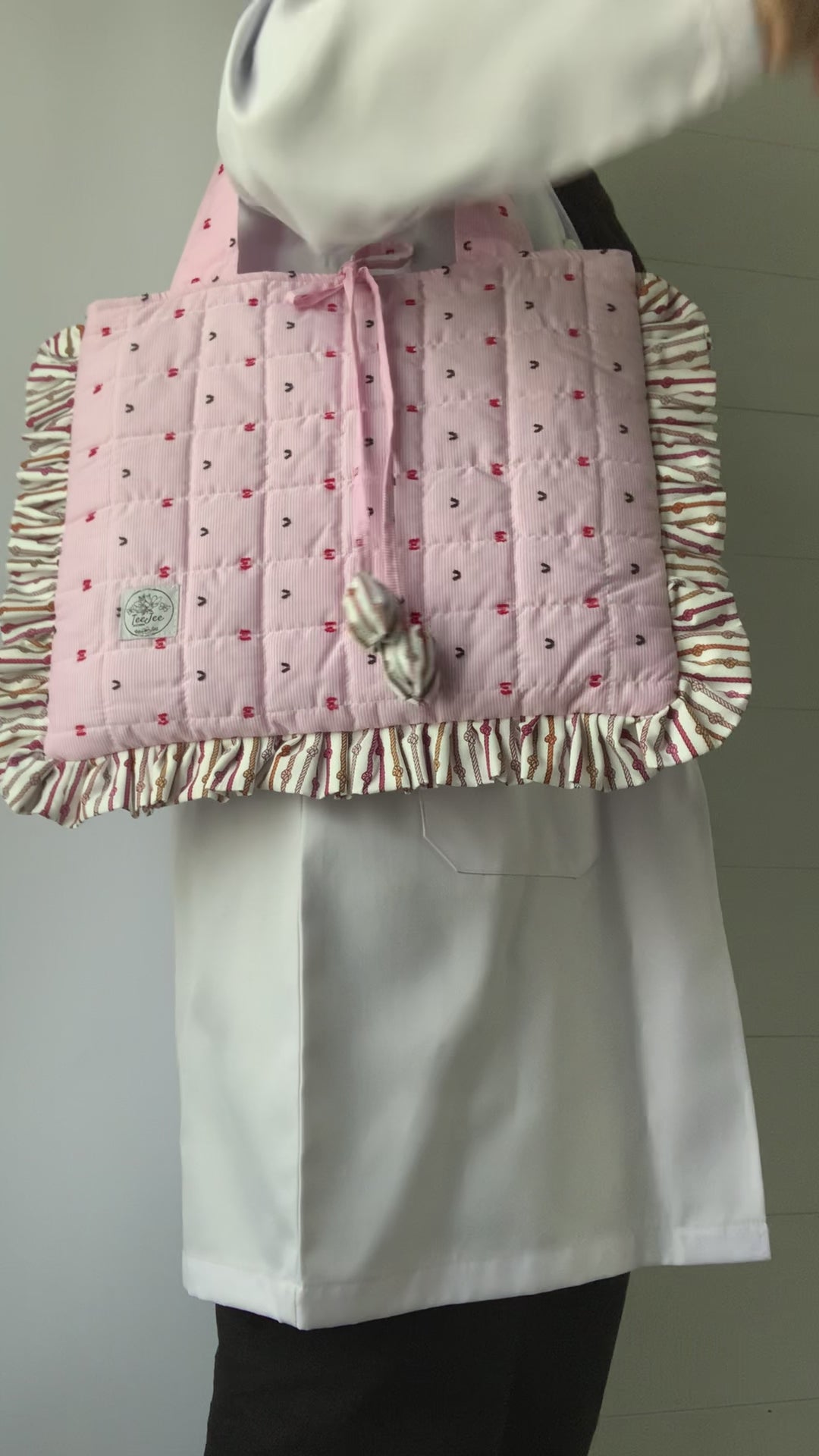 The video shows the tote bag being carried to provide a size reference.